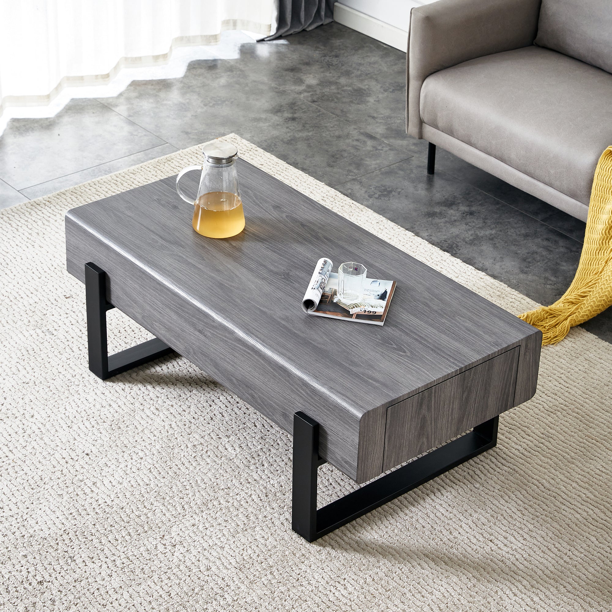 A coffee table made of MDF material. Equipped with drawers made of solid wood material. Can store things and save space. Paired with black metal table legs. Suitable for living room.