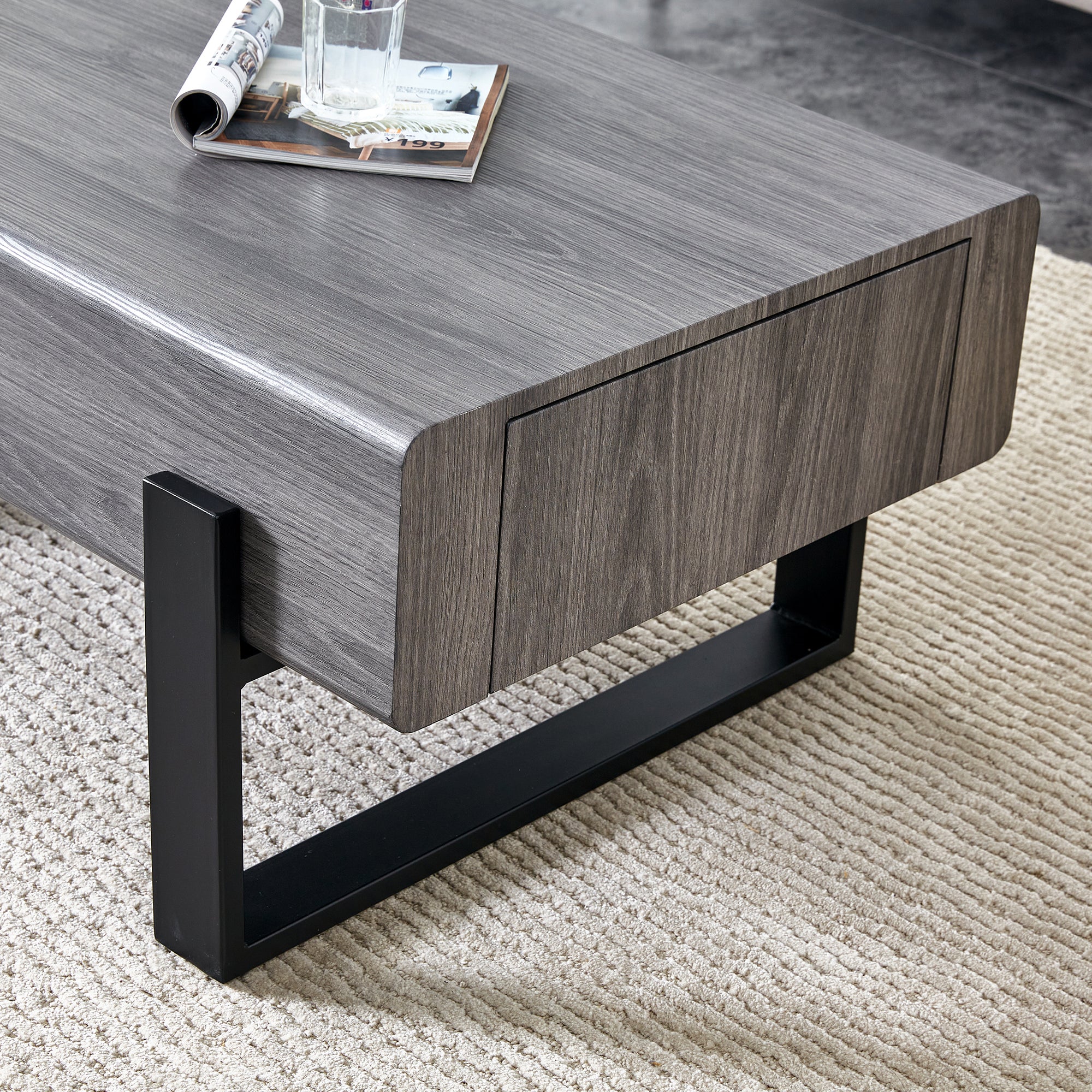 A coffee table made of MDF material. Equipped with drawers made of solid wood material. Can store things and save space. Paired with black metal table legs. Suitable for living room.