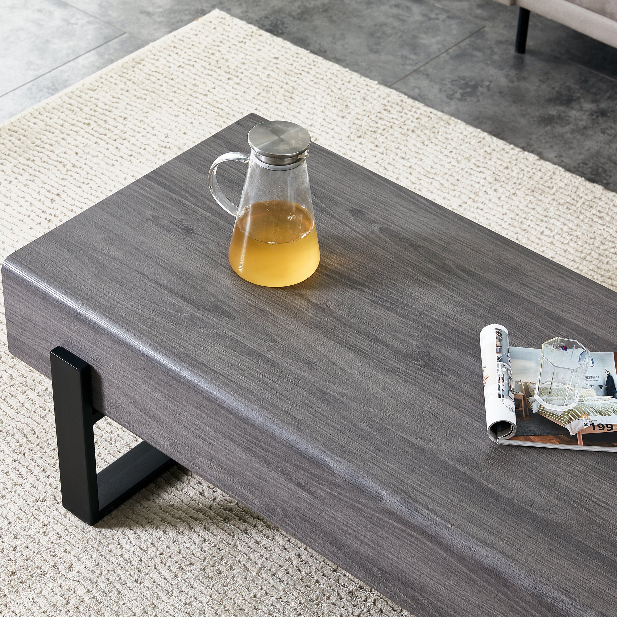 A coffee table made of MDF material. Equipped with drawers made of solid wood material. Can store things and save space. Paired with black metal table legs. Suitable for living room.