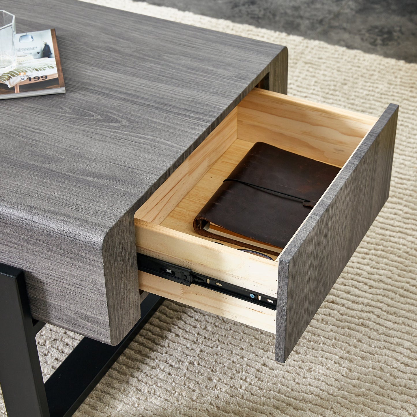 A coffee table made of MDF material. Equipped with drawers made of solid wood material. Can store things and save space. Paired with black metal table legs. Suitable for living room.